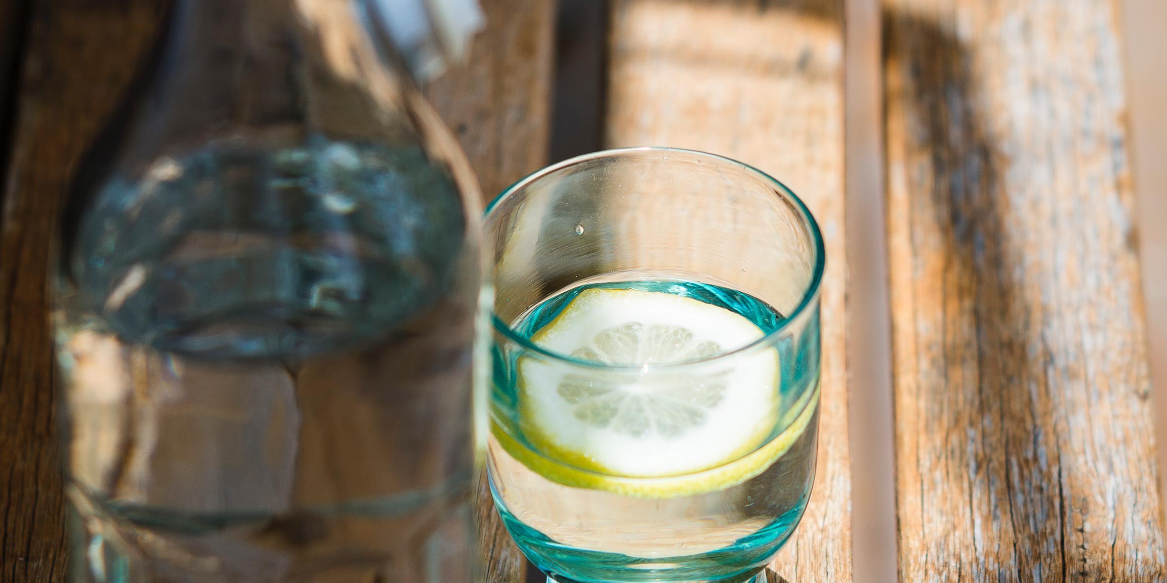 Glass of water with lemon wedge inside natural vitamin c