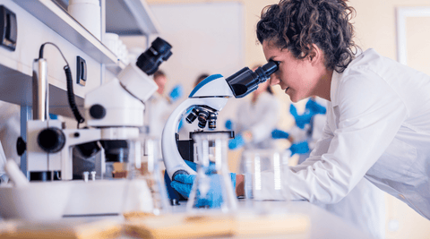 Woman doing research microscope