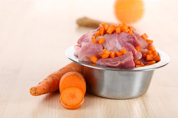 bowl of raw meat and vegetables for pet