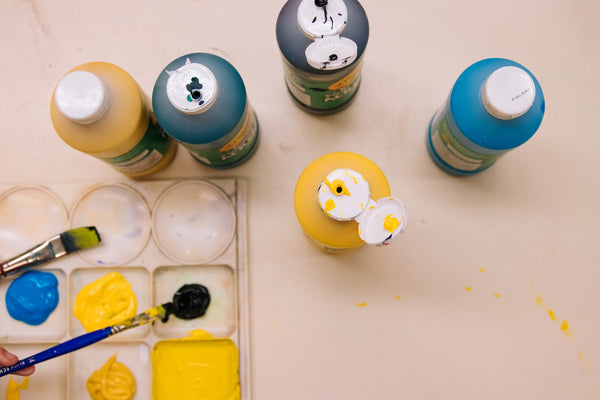 yellow and blue paint bottles