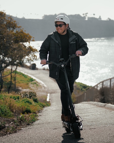 An apollo scooter user riding uphill