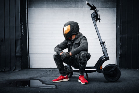 Man sitting on the Apollo Pro electric scooter