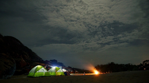 camping ground with tents at night
