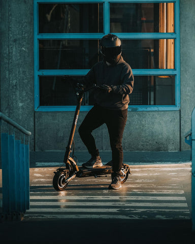 A man on an apollo scooter with a helmet on