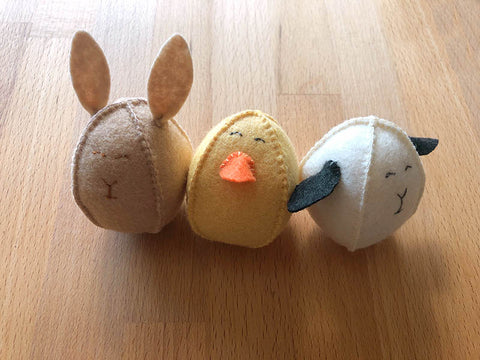 3 felt easter eggs in the shape of a bunny, chick and lamb  