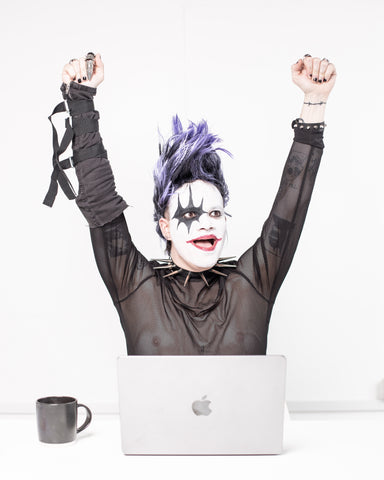 Example of Corpse Paint - Male person in front of laptop wearing corpse makeup