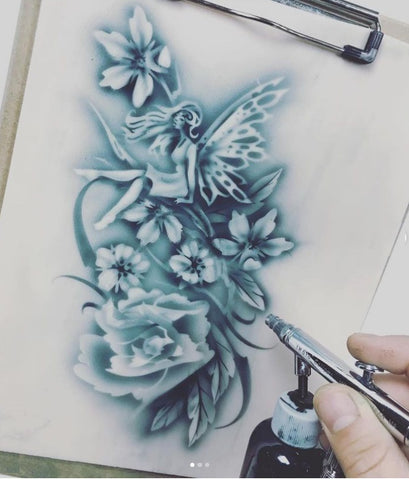Wiser Oner using Tattoo Pro Stencils to paint a fairy in the flowers