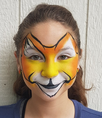 Adding line work to tiger face makeup by Anna Wilinski