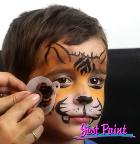 Adding stencil stripes to face painting