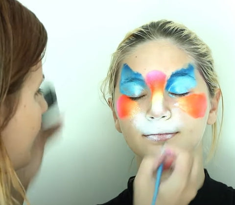 Painting the base of a cat face paint design