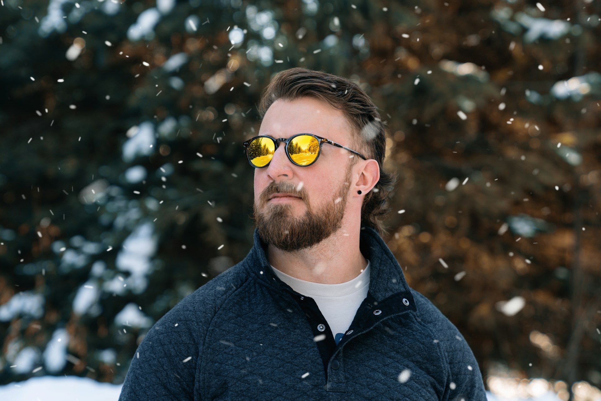 Man standing in the snow with sunglasses on