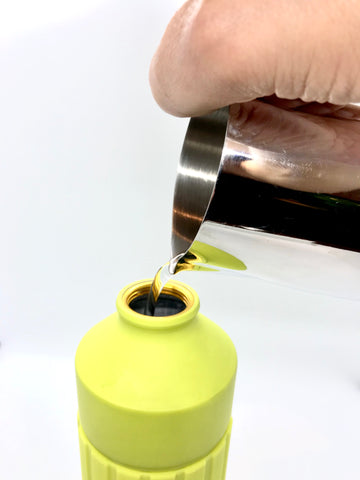 Adding water to cocktail shaker for iced matcha latte