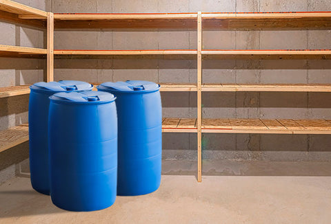 3 blue water barrels inside a home cold storage.