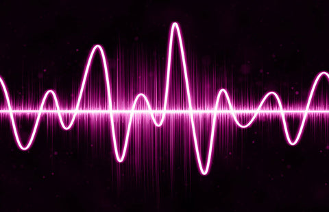 Neon pink soundwaves on a black background.