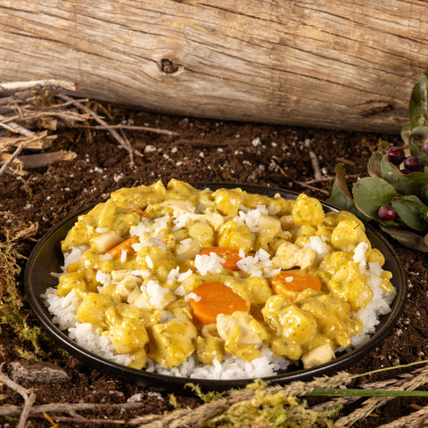 Bowl of Beyond Yellow Chicken Curry on the ground outdoors