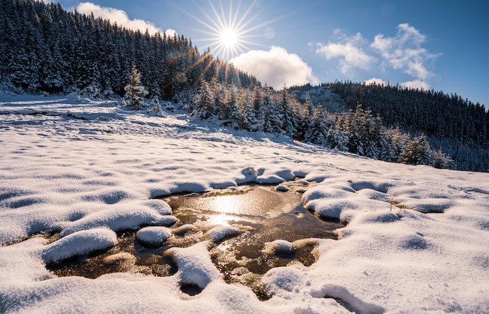 Ice and snow melting on a lake in the mountains.