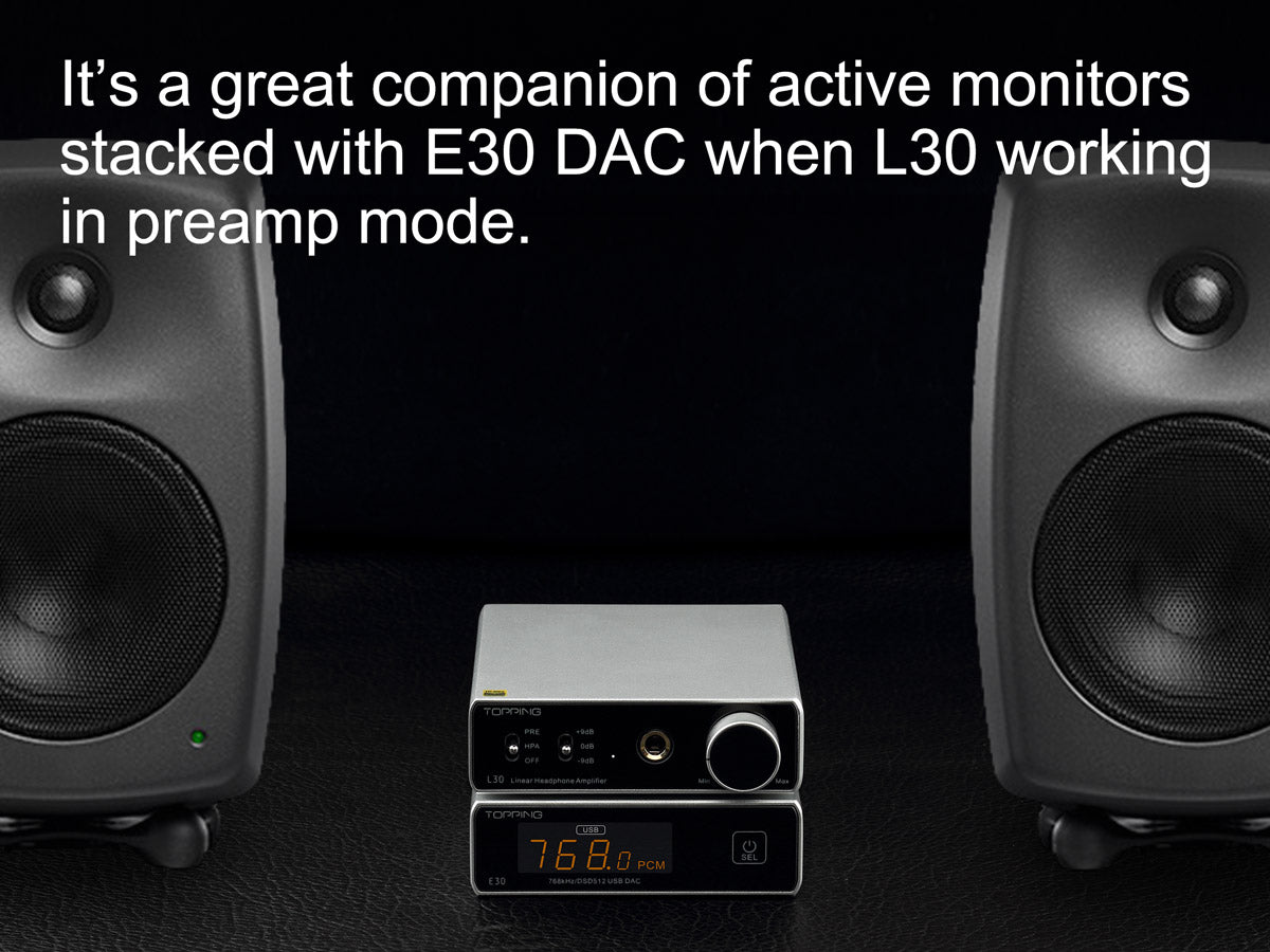 TOPPING L30 headphone amplifier between two black studio monitors