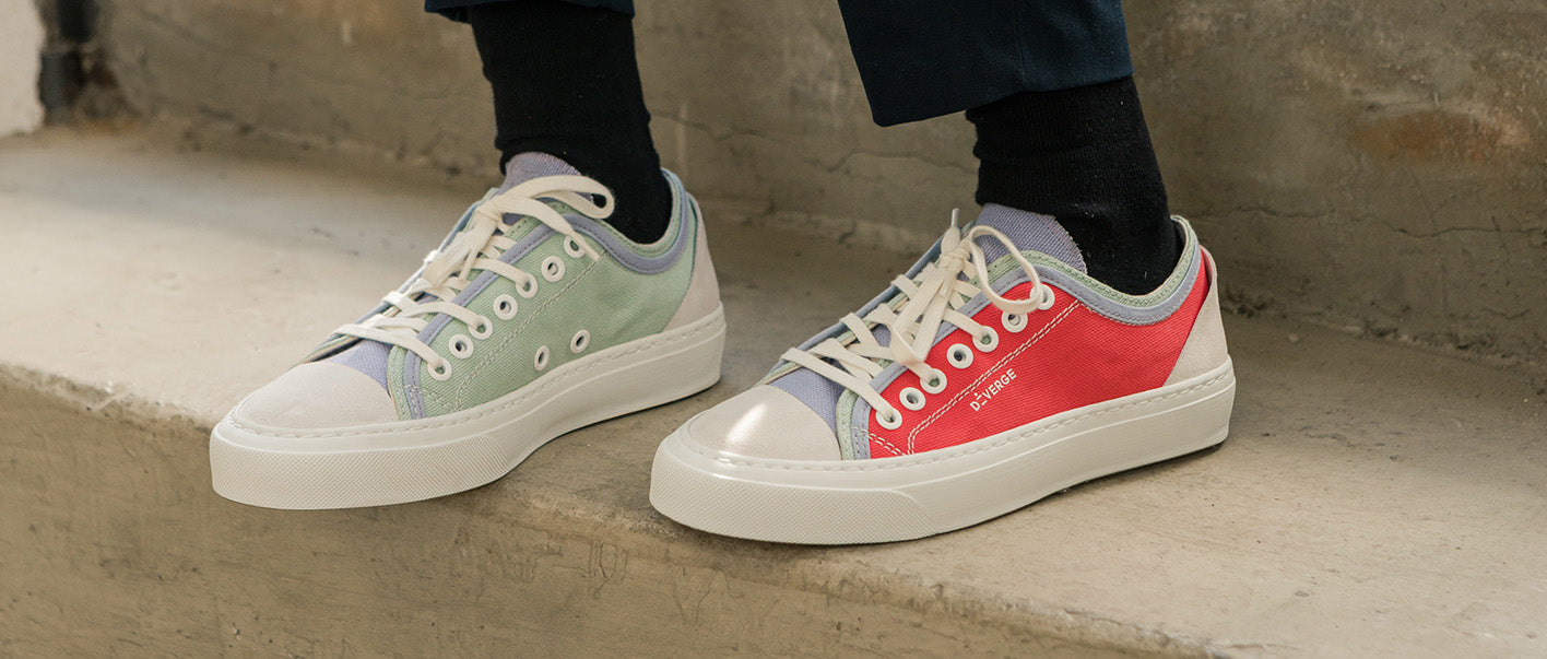 Black and white low top sneakers for women on a concrete floor.