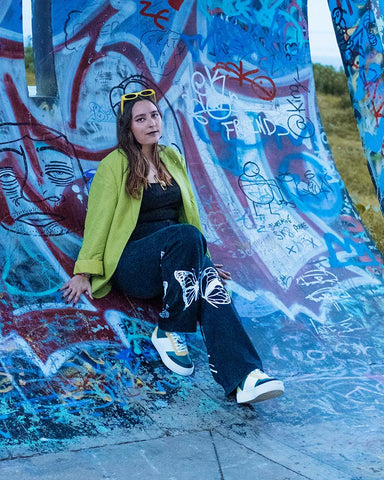 Jessica wearing custom shoes, showcasing Diverge sneakers and promoting social impact through the Imagine project.