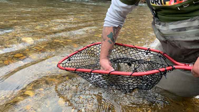 Fishermen catch fish with a huge fishing net with a length of