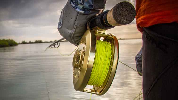 Salt water fly fishing reel in mans hand