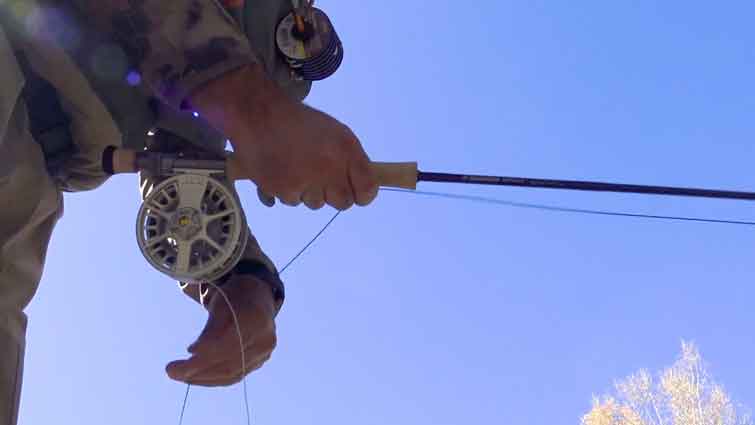 Fly Fishing Rod in mans hands