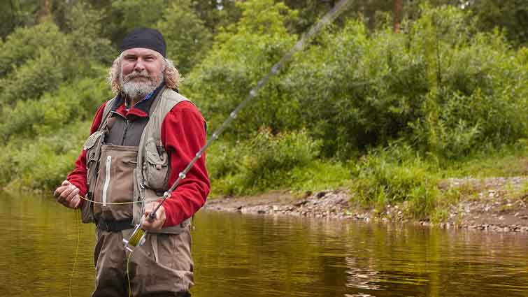 Man in River with Fly Fishing Vest