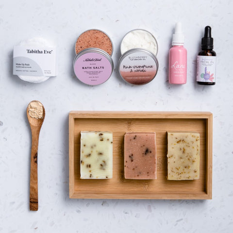 natural, vegan and plastic free skincare products laid out on white background.