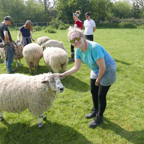 the kind store founder Natasha Lovegrove at Tower Hill stables vegan animal sanctuary stroking a rescued sheep