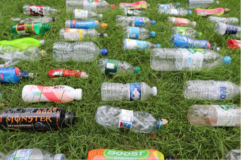 plastic bottles laid out on the grass.