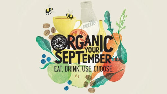 organic september logo organic your september with fruit and vegetables behind text.