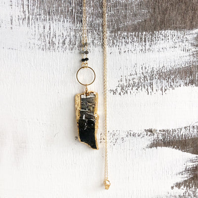 Long Black Grey and White Stone Slice Pendant Necklace with Ring and Bead Accent in Gold.