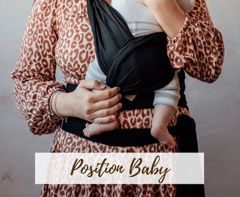 Position baby in wrap carrier