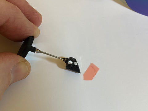 Remove the red backing from the magnetic attachment.