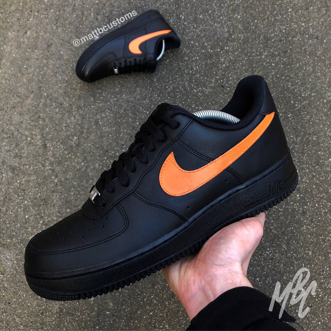 black nike with orange swoosh