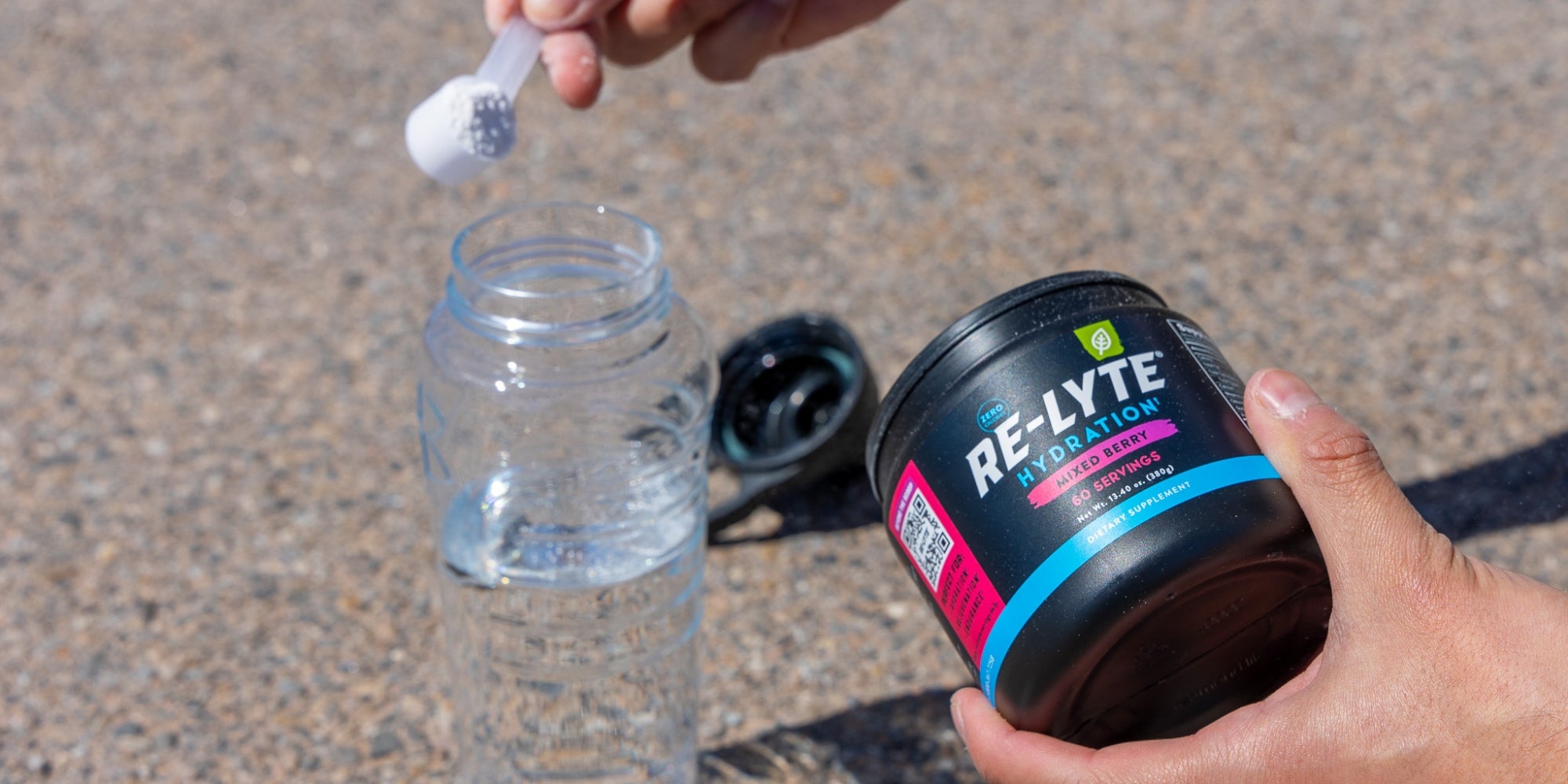 Pouring Redmond Electrolyte Powder into a water bottle