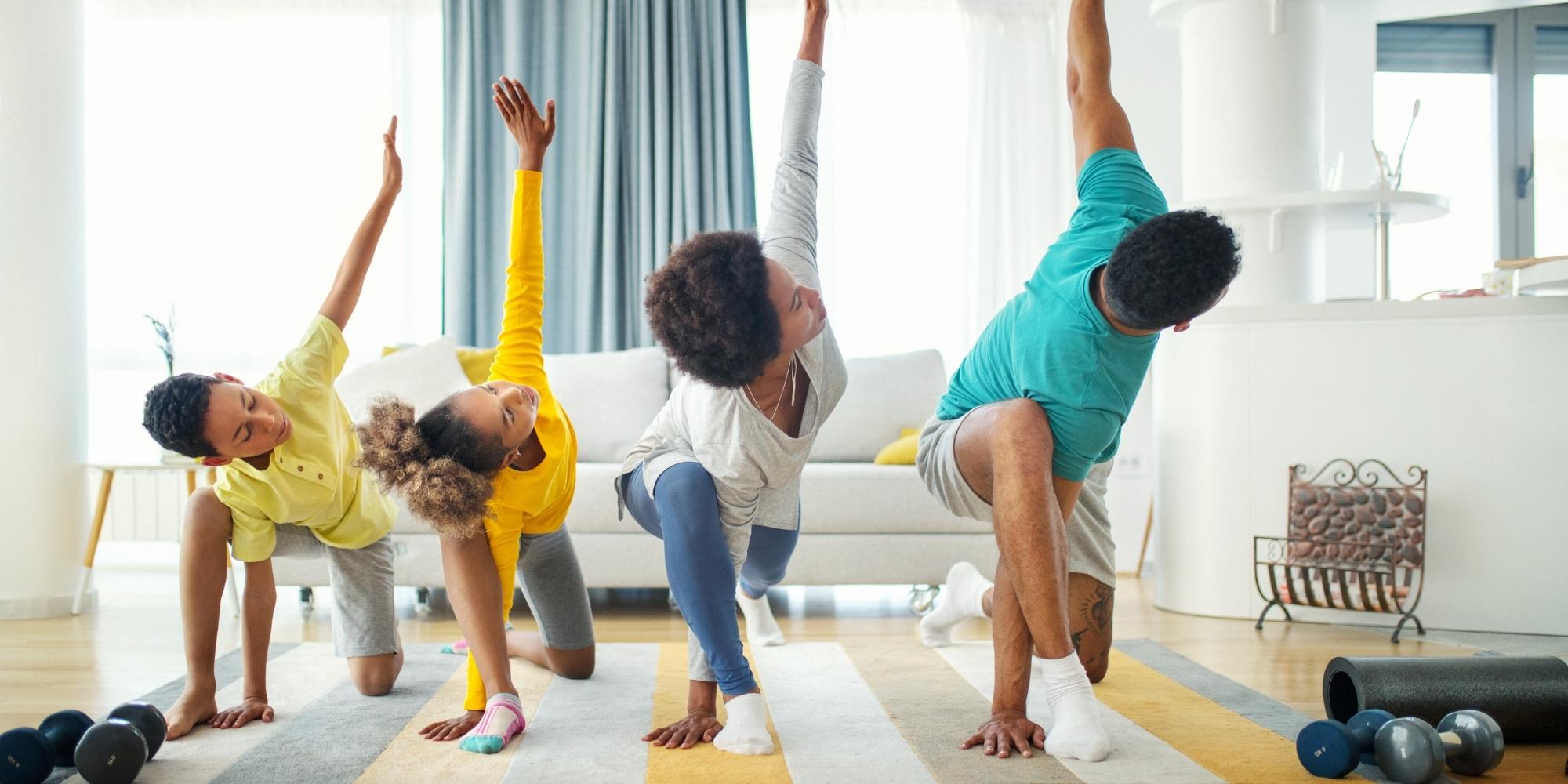family doing yoga in living room