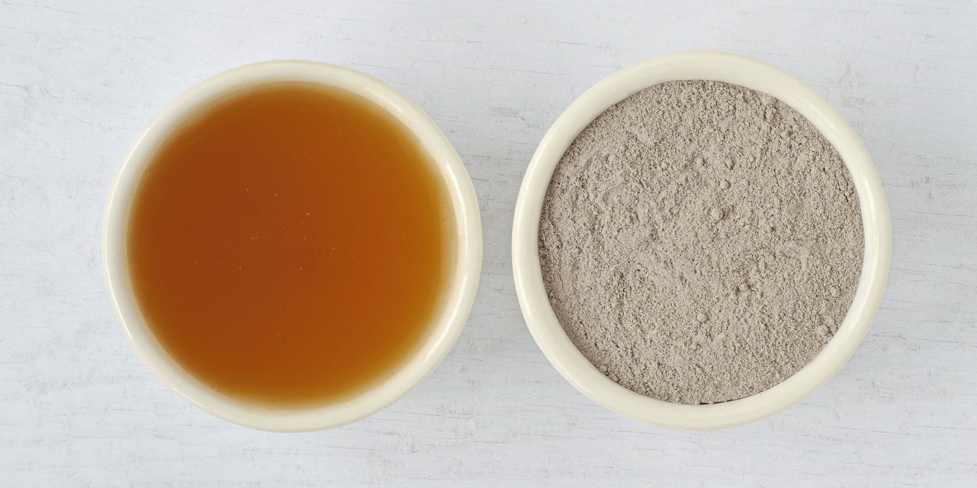 small bowl of Bentonite clay next to a small bowl of Apple Cider Vinegar