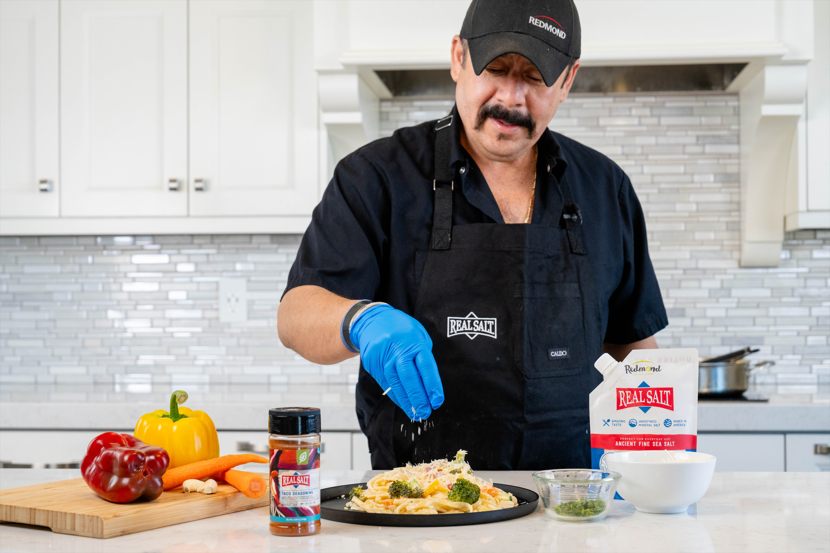 Monce Pouring parmesan cheese on food