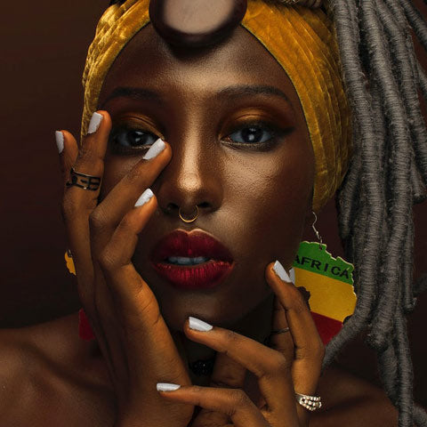 african lady wears earrings made of wood