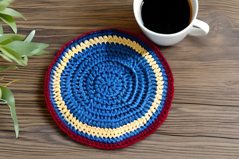 crochet drink coaster with a cup of coffee