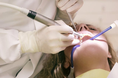 dentist working on woman's teeth