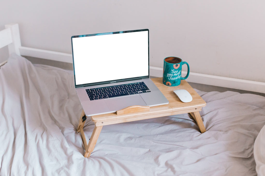 wooden table for the laptop on the bed