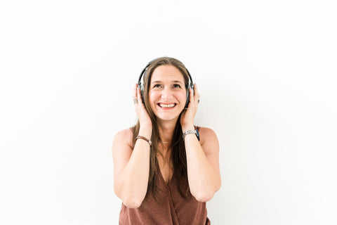 an emotional woman listens to a music