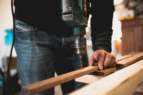 man drilling hole