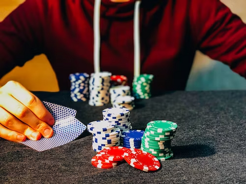 a man playing poker with cards and chips