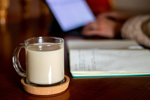 the wooden coaster and the milk