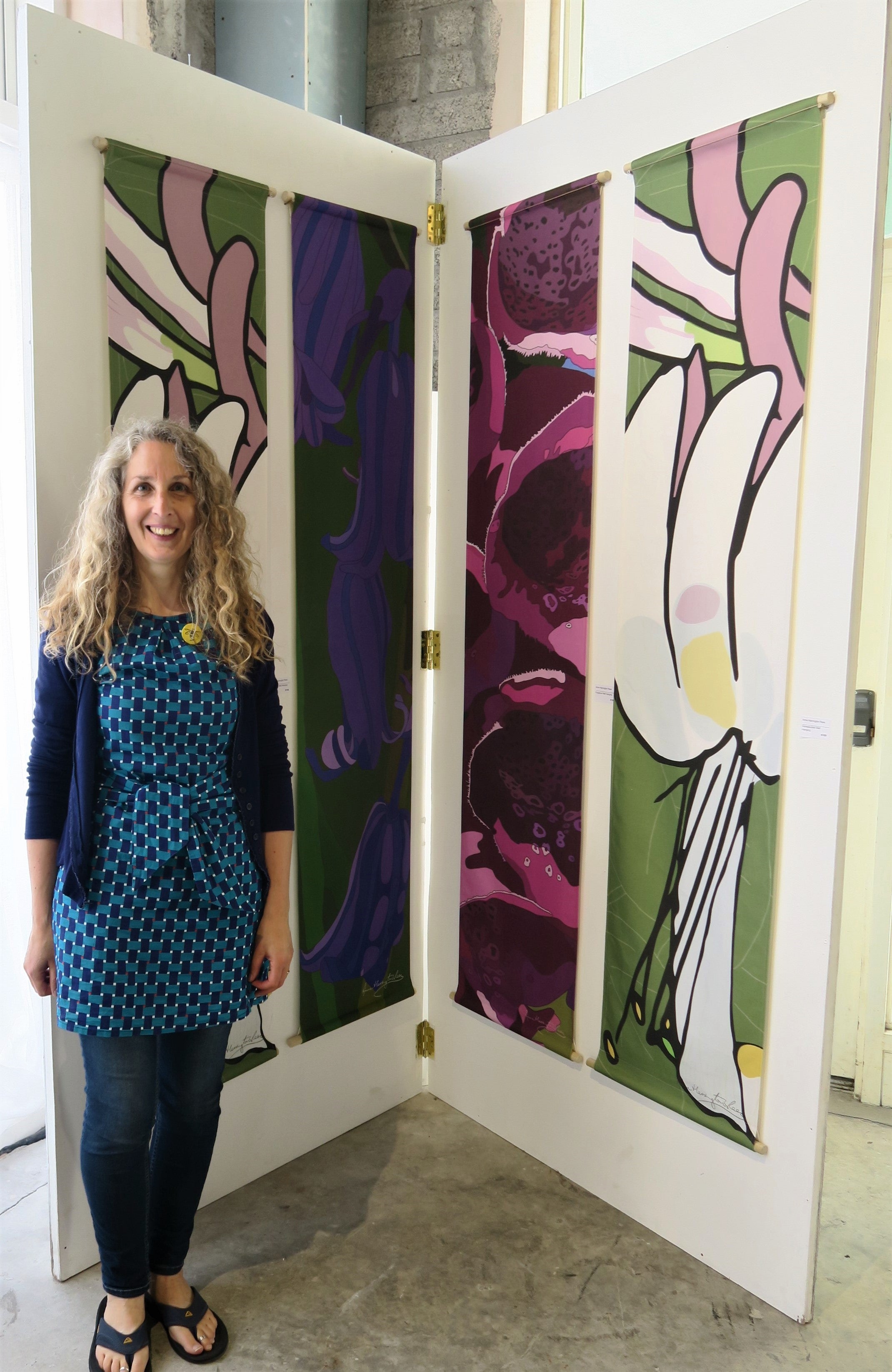 Anne Harrington Rees in front of Honeysuckle, Bluebell and Foxglove wall hangings at the opening of West Cork Creates 'Into the Woods', Skibbereen, August 2019