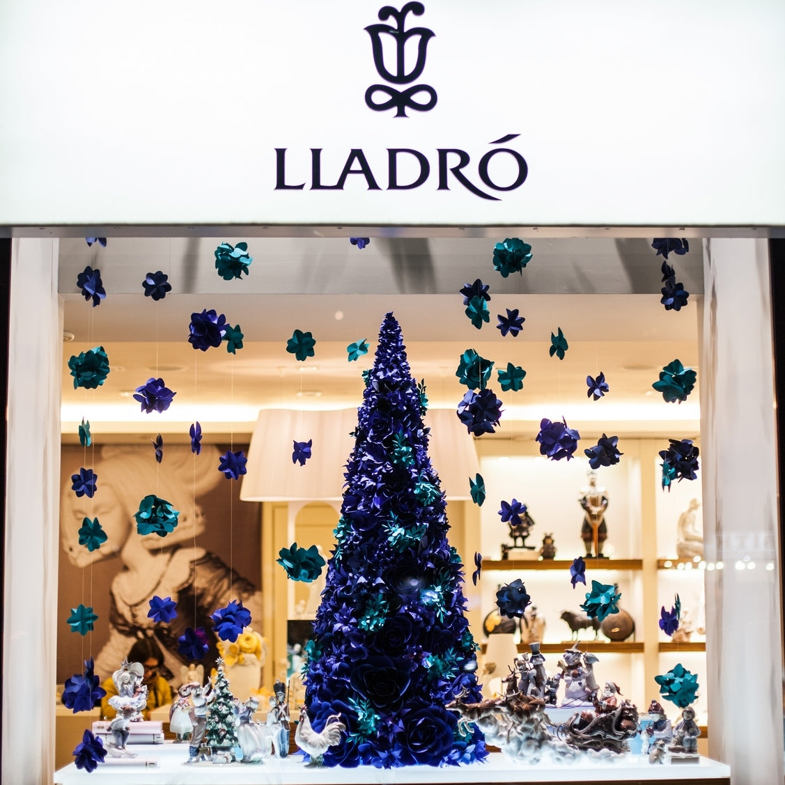 Paper flower Christmas tree in ultramarine blue and turquoise blue with hanging paper hydrangeas for Lladró winter display.