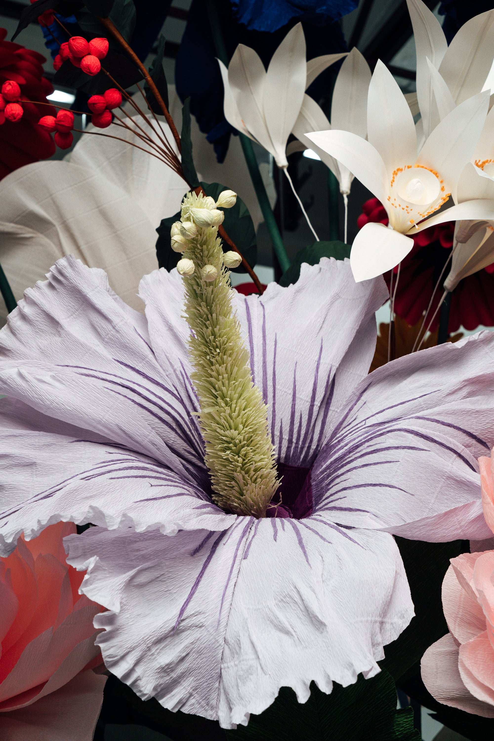 Tiges emmêlées et fleurs vibrantes dans l'installation de fleurs en papier